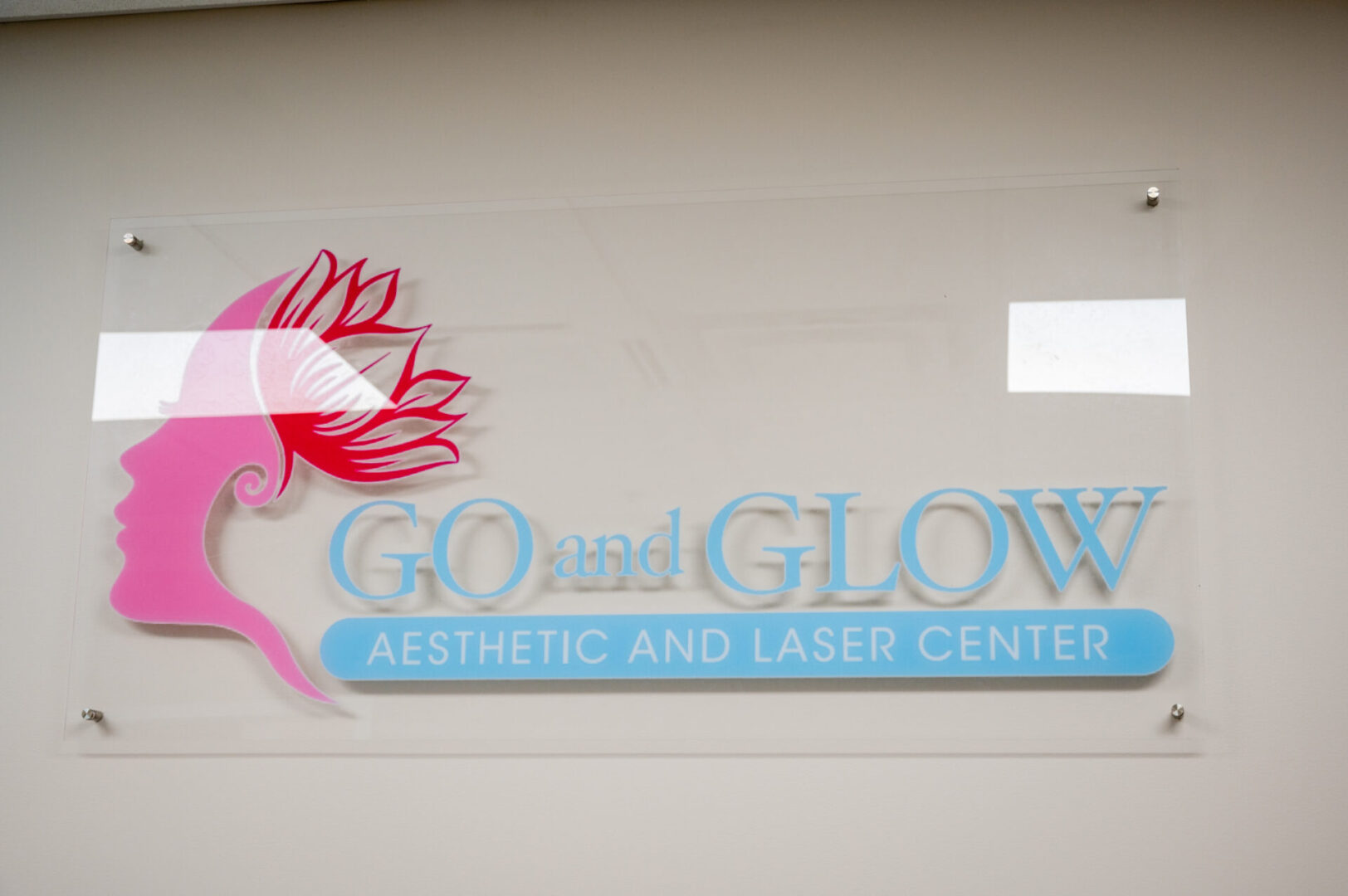 A sign that says go and glow aesthetic and laser center.