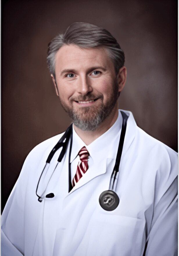 A male doctor wearing a white lab coat and stethoscope.